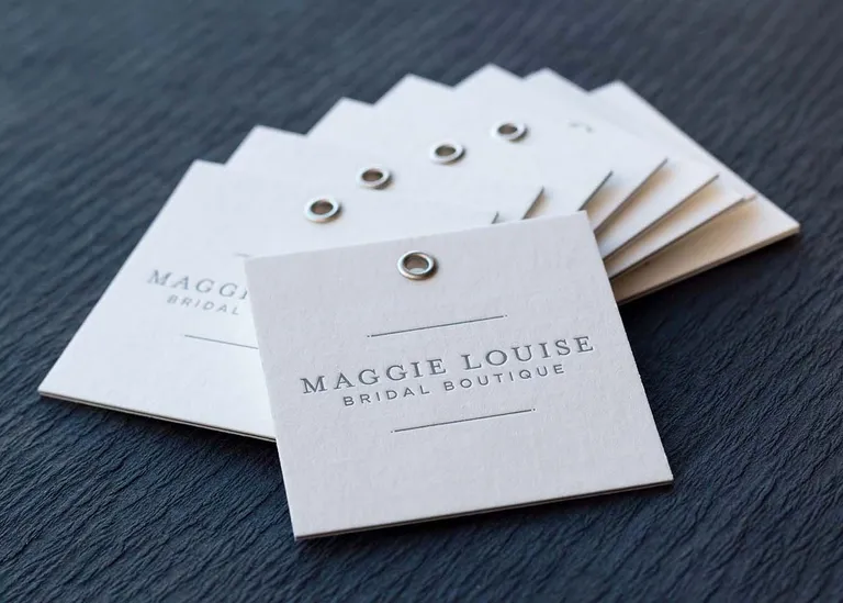 Letterpress printed hang tag with metal eyelet, hung from twine