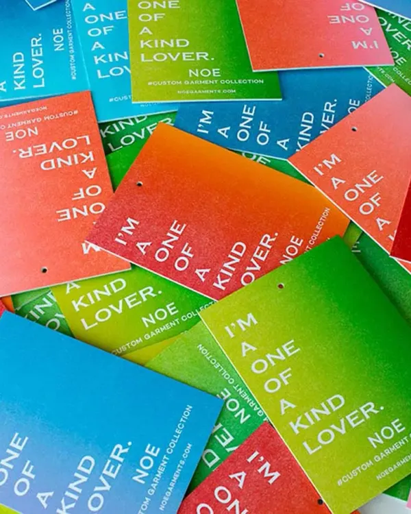 Colorful rainbow roll letterpress hang tags showing split fountain ink gradient on duplexed stock