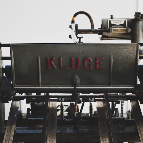 Detail of the KLUGE manufacturer nameplate on the press