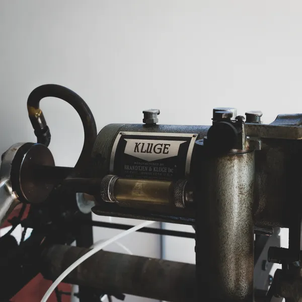 Wide view of the Kluge press with a copper foil curtain hanging mid-job