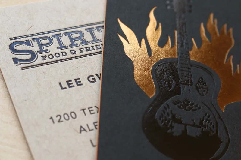 Copper foil stamping on quadplexed black cotton paper for a spirits brand