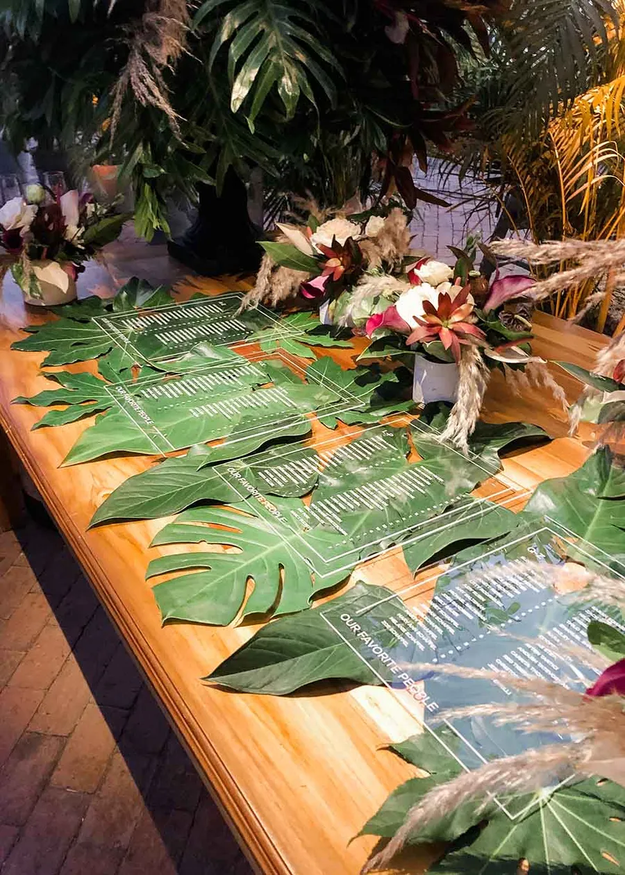 Acrylic screenprinted seating chart on monstera leaves
