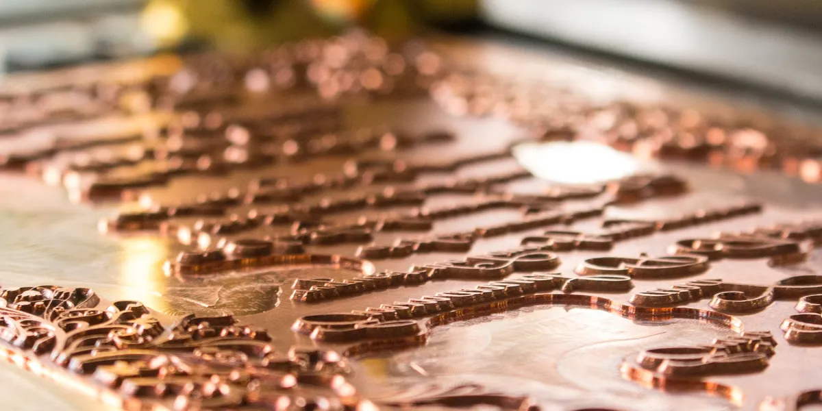 Copper foil stamping dies with raised letterforms mounted for the press