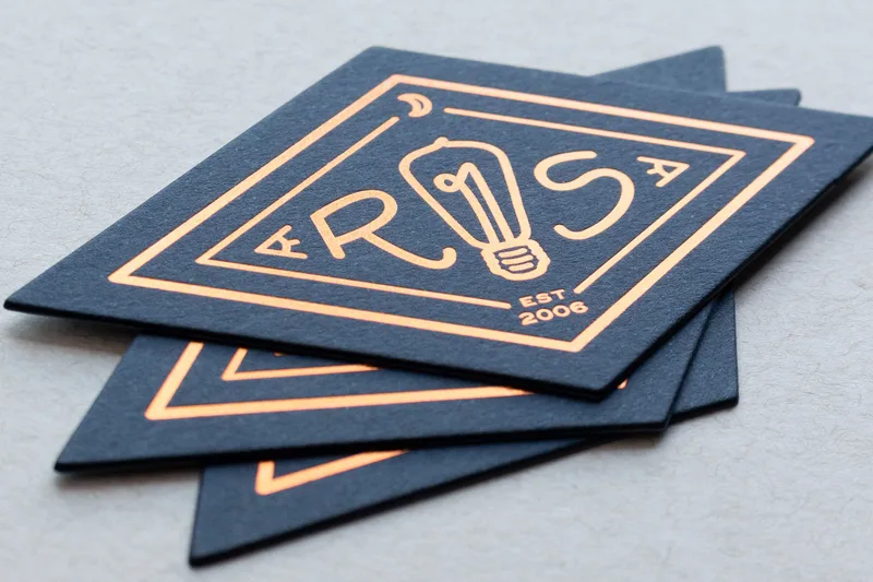 Diamond-shaped die-cut business cards with copper foil stamping