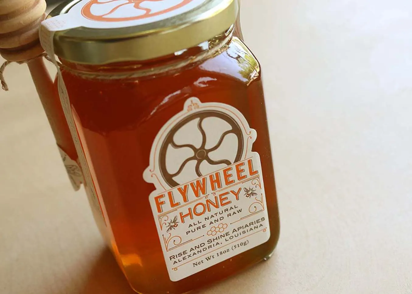 Die-cut letterpress honey jar labels applied to glass jars showing front and top label designs