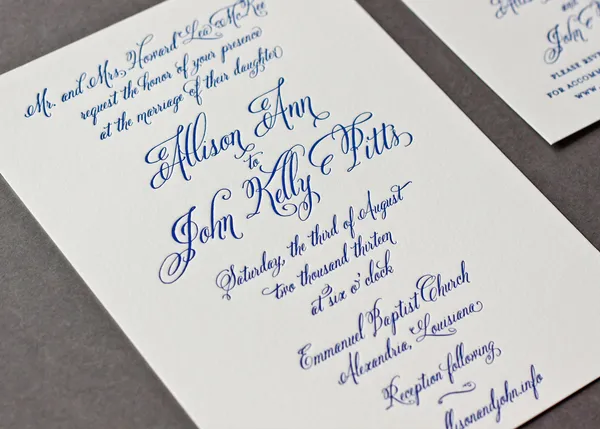 Letterpress wedding invitation printed in cobalt blue on cream cotton stock with elaborate flourished copperplate calligraphy