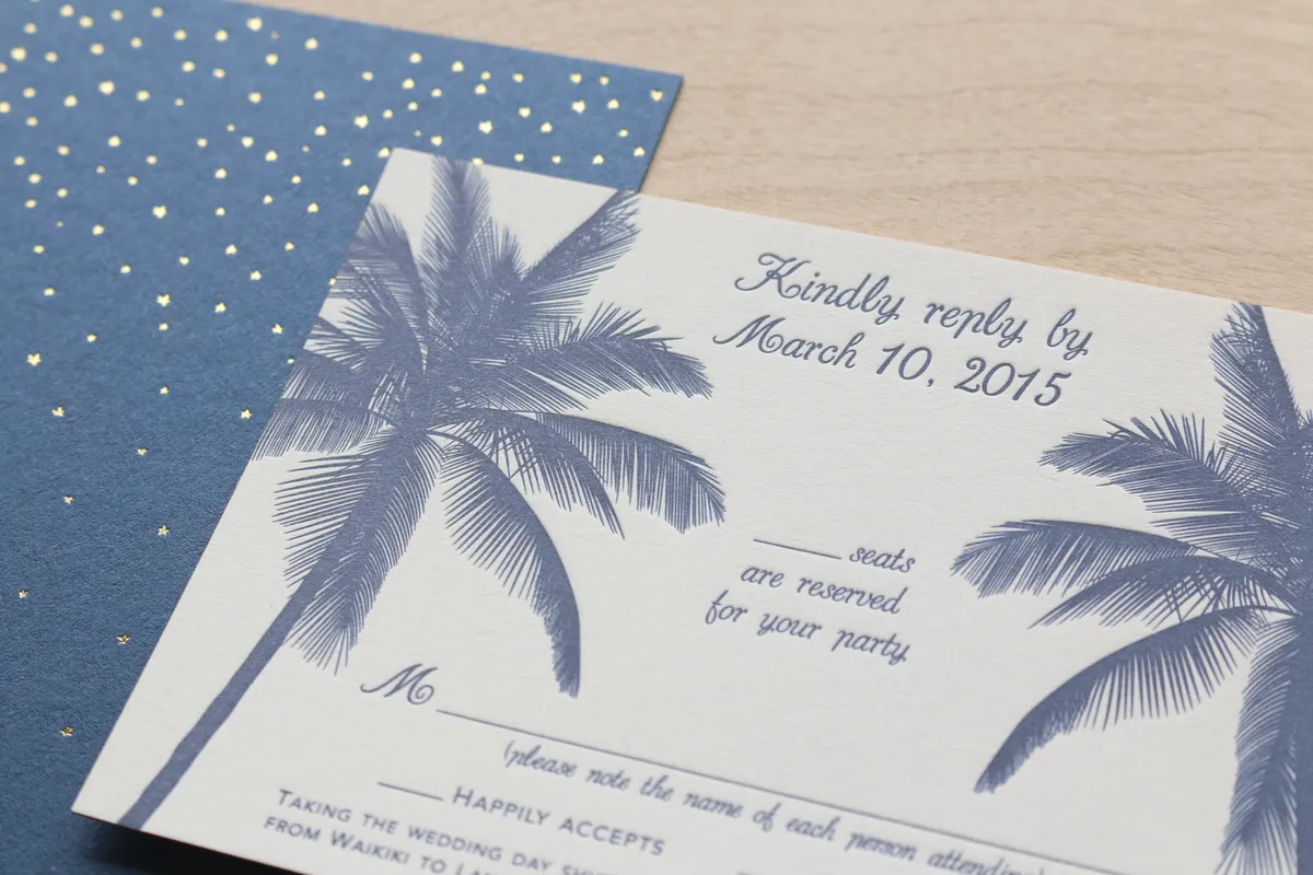 Letterpress RSVP card with two large soft-blue palm tree illustrations and hand-lettered reply field