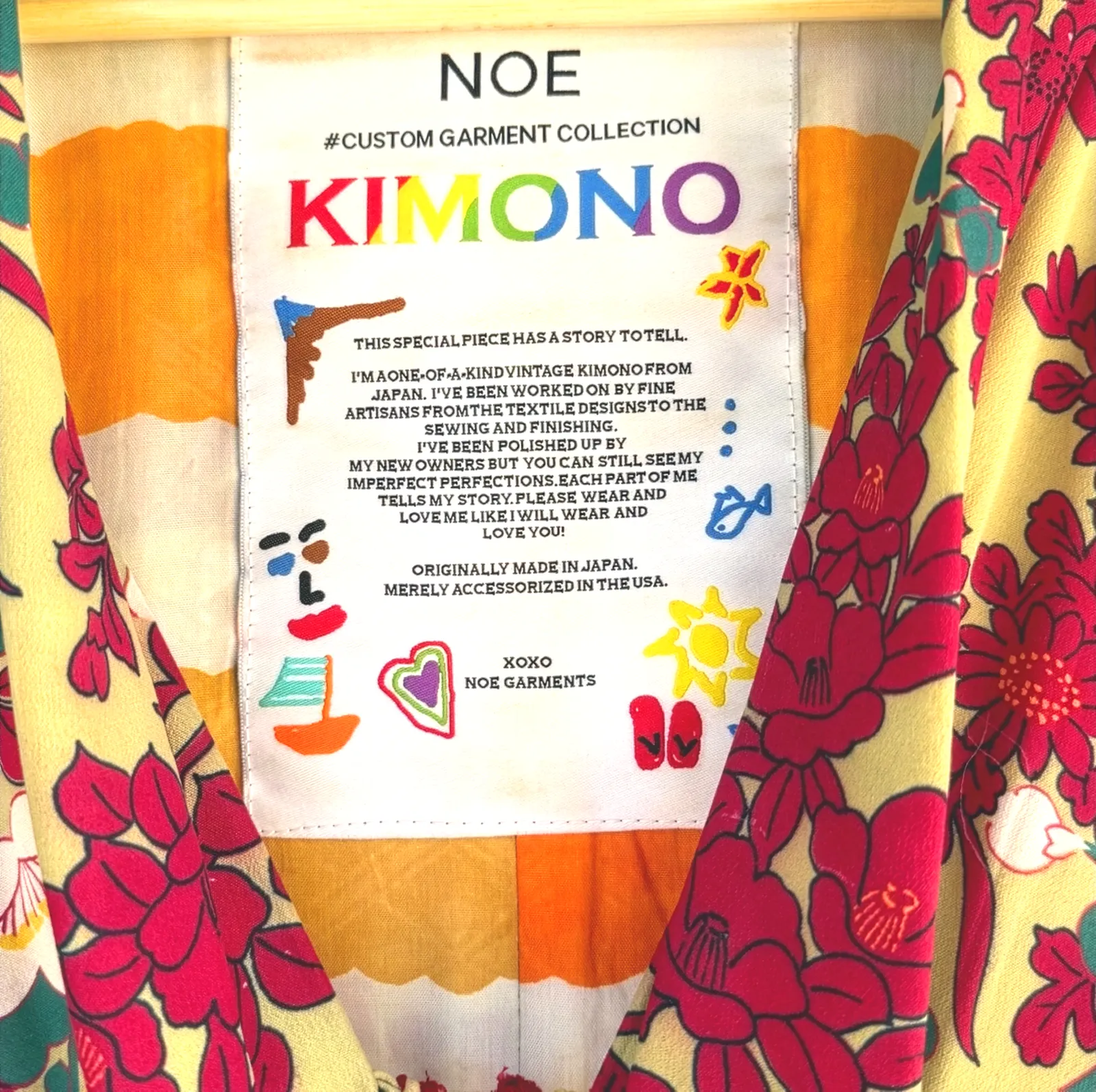Noe hang tag attached to a vintage Japanese kimono, showing the reverse side printed with the brand story about one-of-a-kind garments