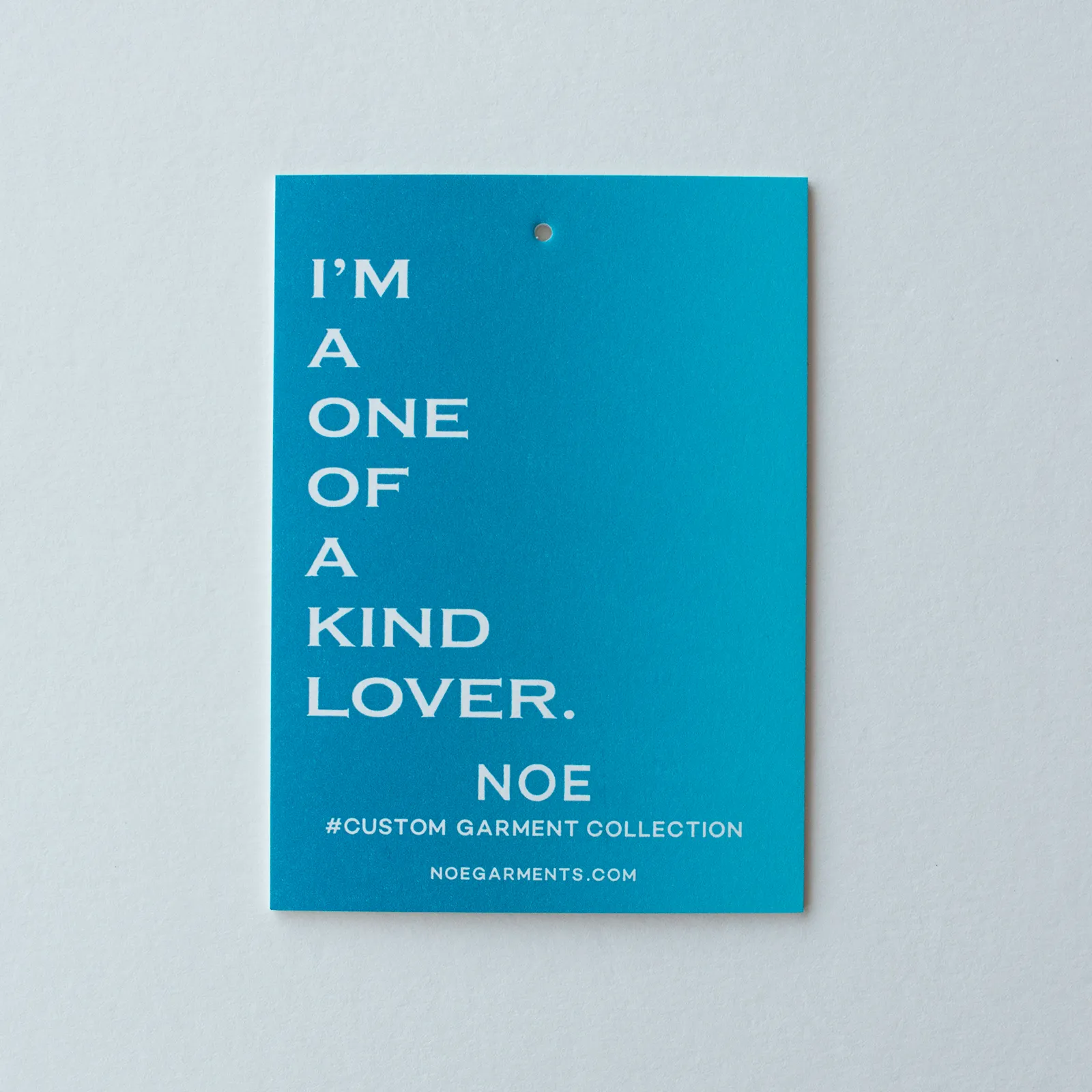 Five rainbow roll hang tag colorways displayed in a row on a soft background: blue, red-to-orange, pink-to-coral, green, and teal