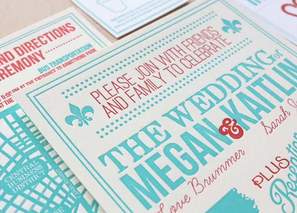 Two-color letterpress wedding invitation suite in blue and red on white cotton paper
