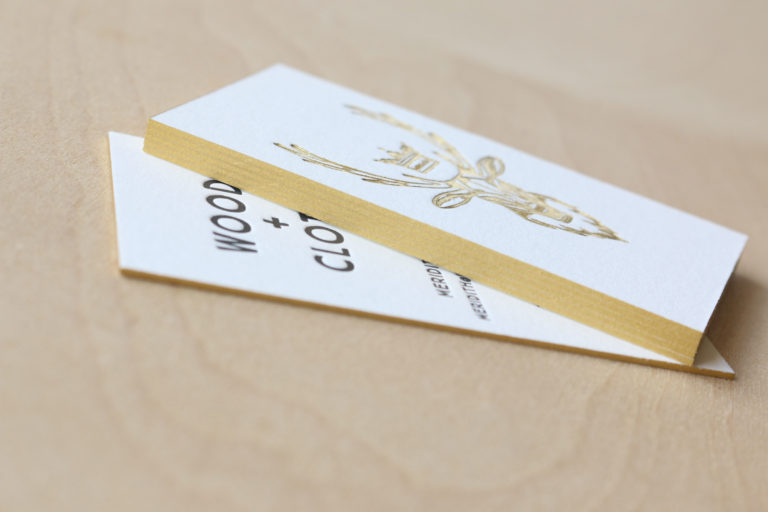 Black ink letterpress with gold foil business card with gold edge painting