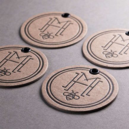 Black ink on chipboard hang tags with eyelets