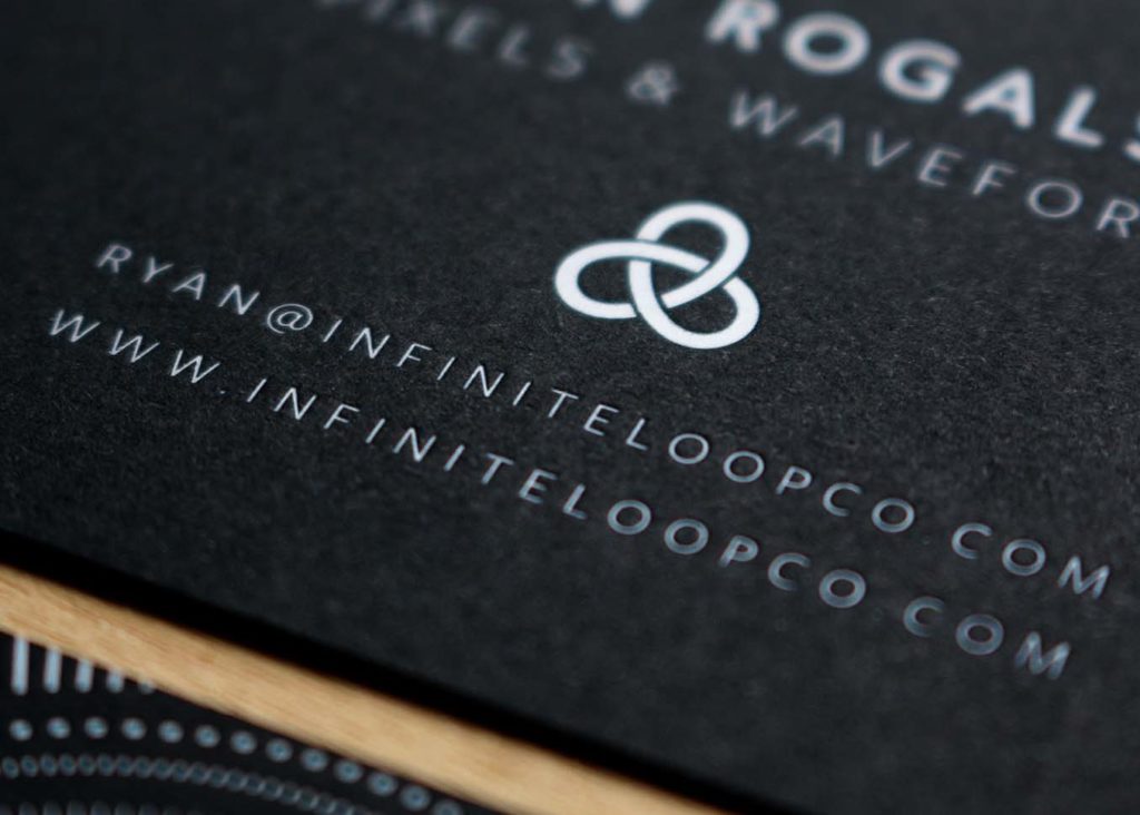 White foil stamping on black paper business card