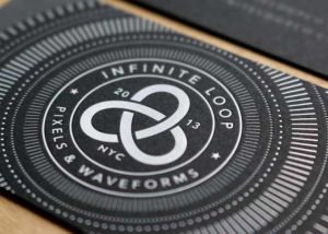 White foil stamping on black paper business card